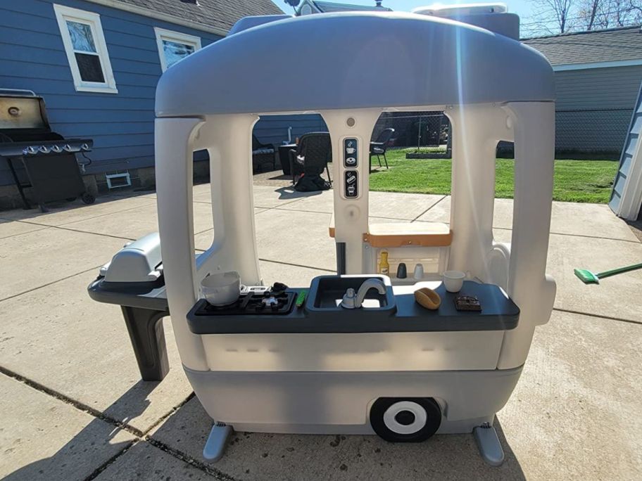Step2 Adventure Camper Playhouse for Kids in a driveway