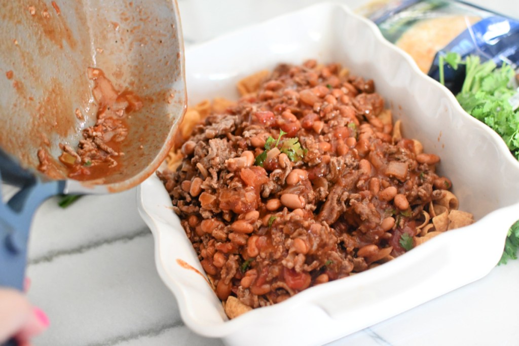 adding chili to casserole dish