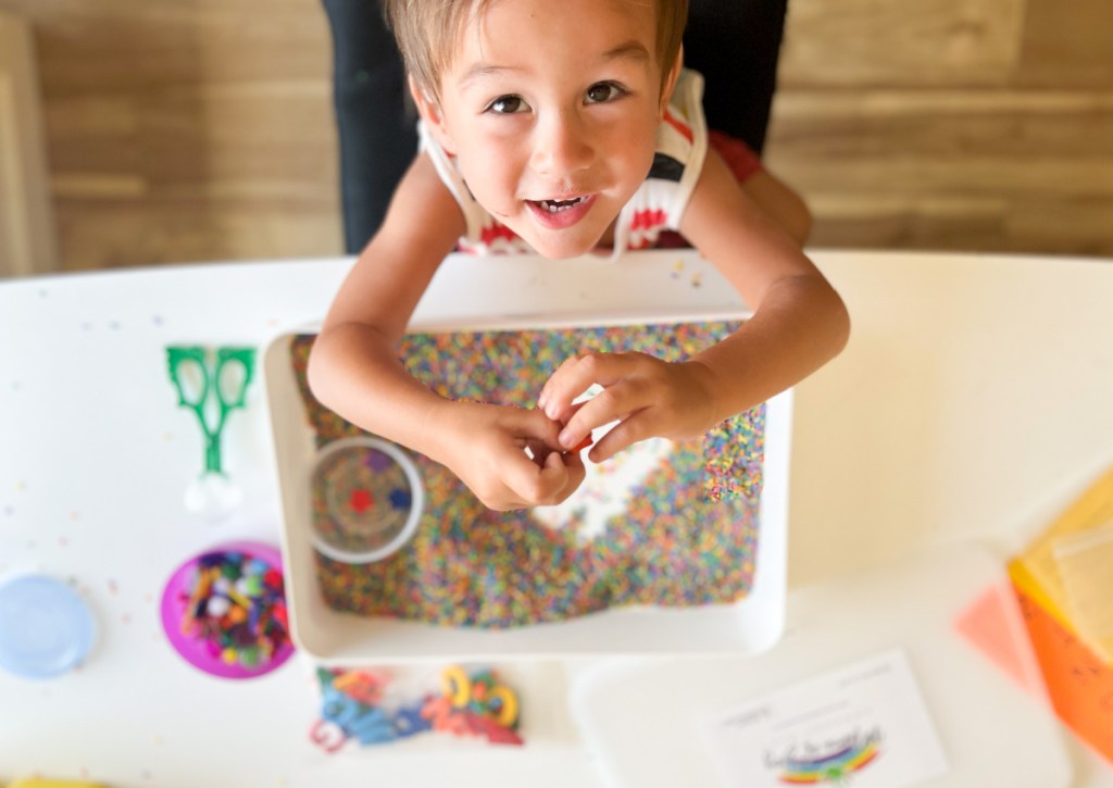 boy playing with mama of joy sensory bin