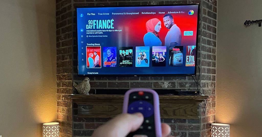 remote pointing at TV with Discovery+