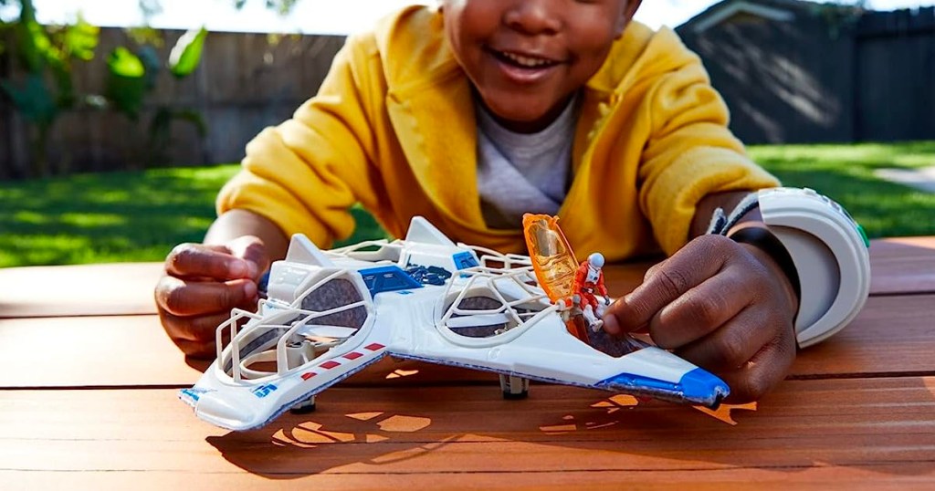 child playing with RC lightyear hot wheels plane