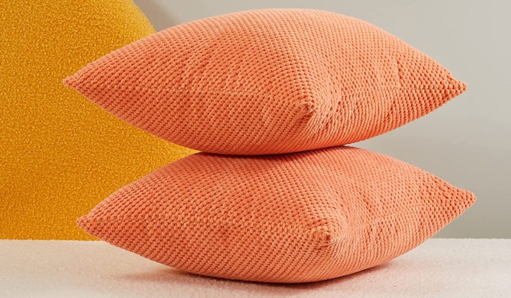 two orange pillows stacked
