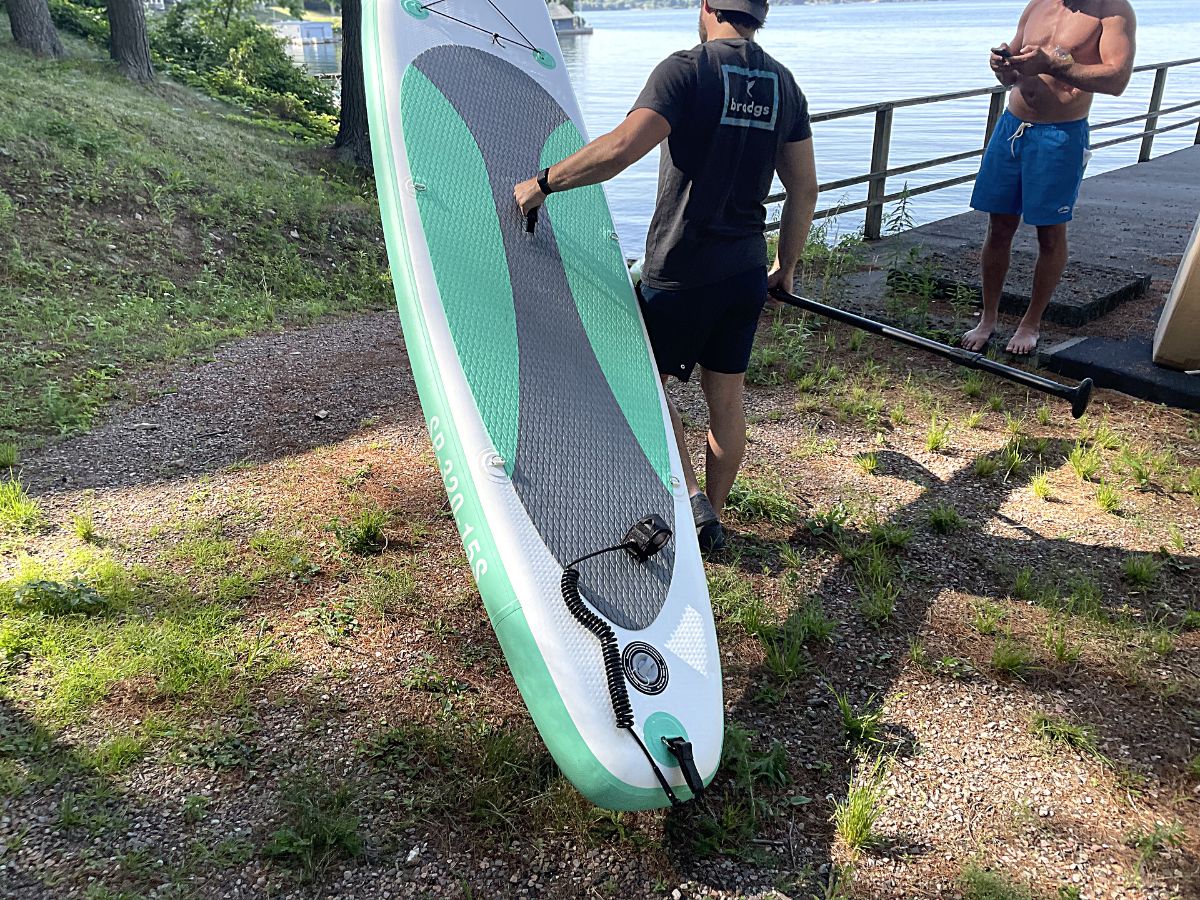 man carrying inflatable kayak