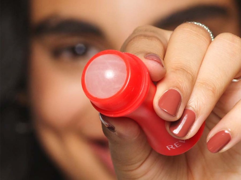 woman showing off a revlon skin reviving roller