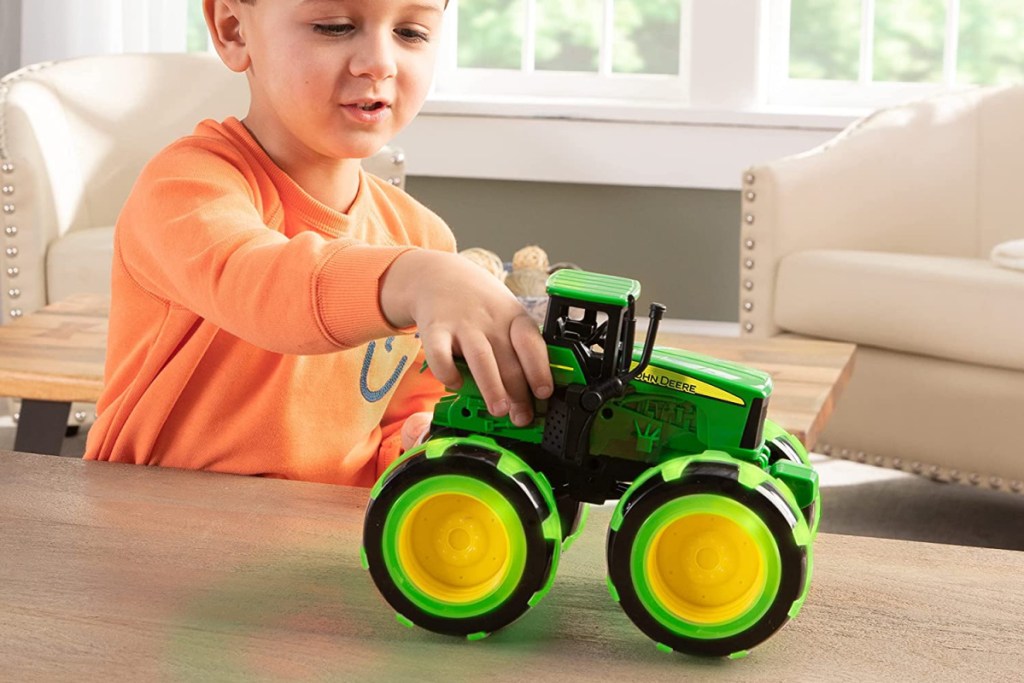 kid with toy tractor 