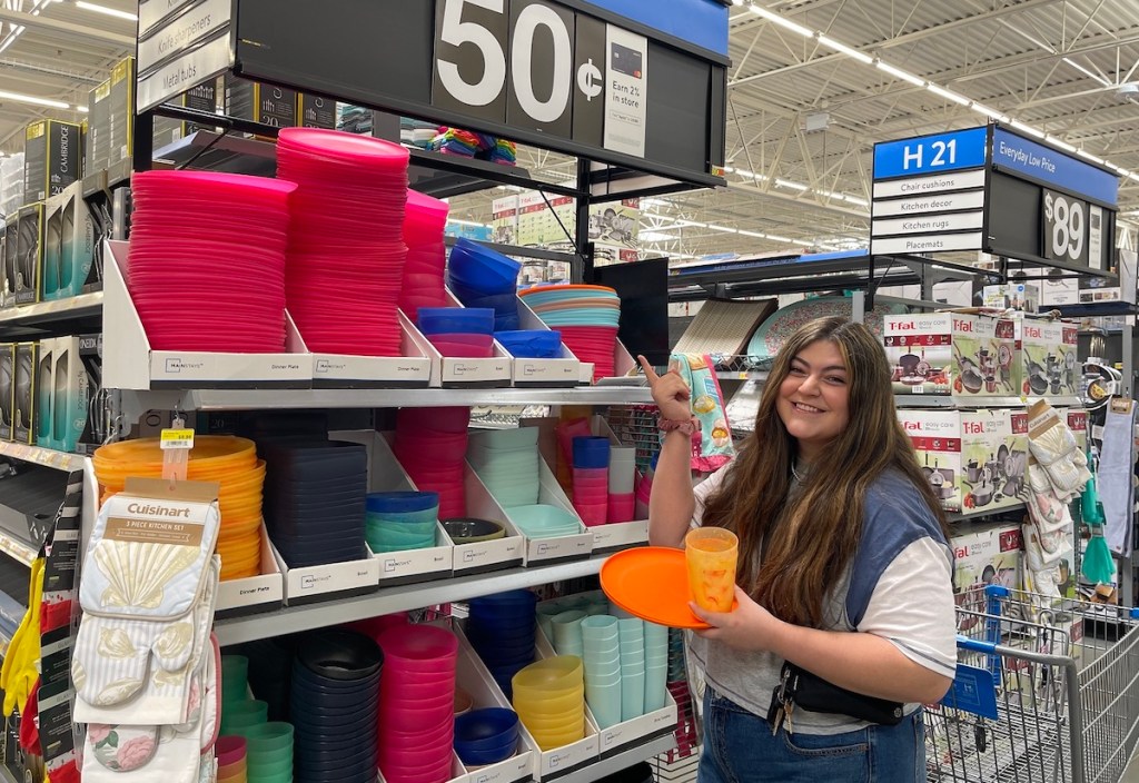 woman standing with 50 cent dishes in walmart