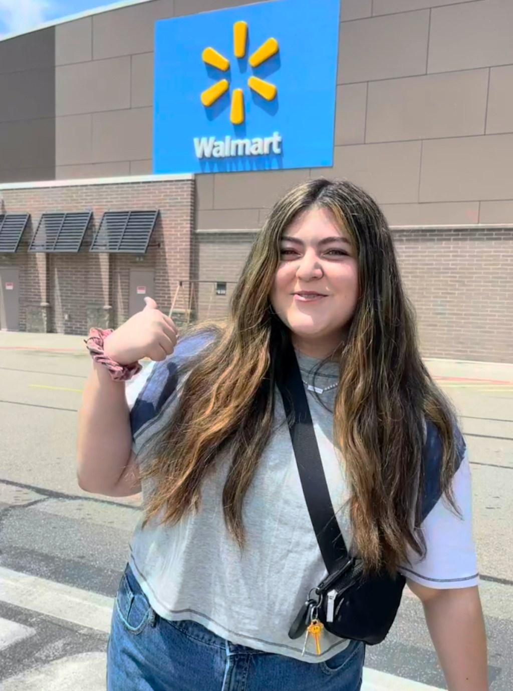 woman standing outside of walmart store front