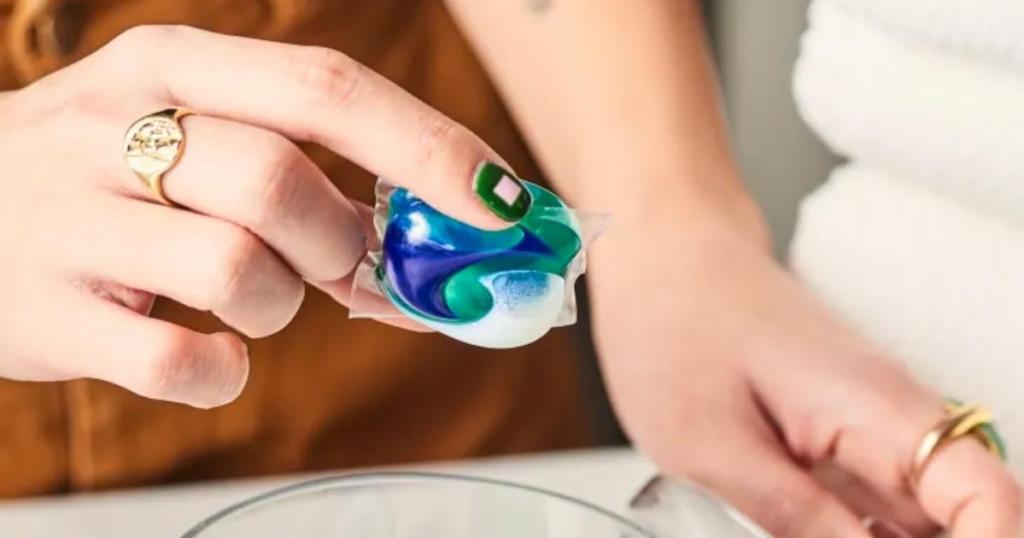 person holding cascade platinum dishwash pod