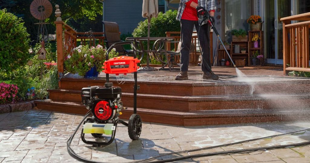 using a pressure washer on a deck