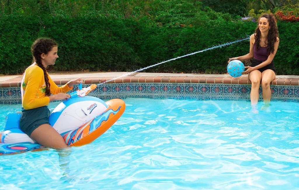 Girl on a Nerf Super Soaker Stormforce Ride On Pool Racer