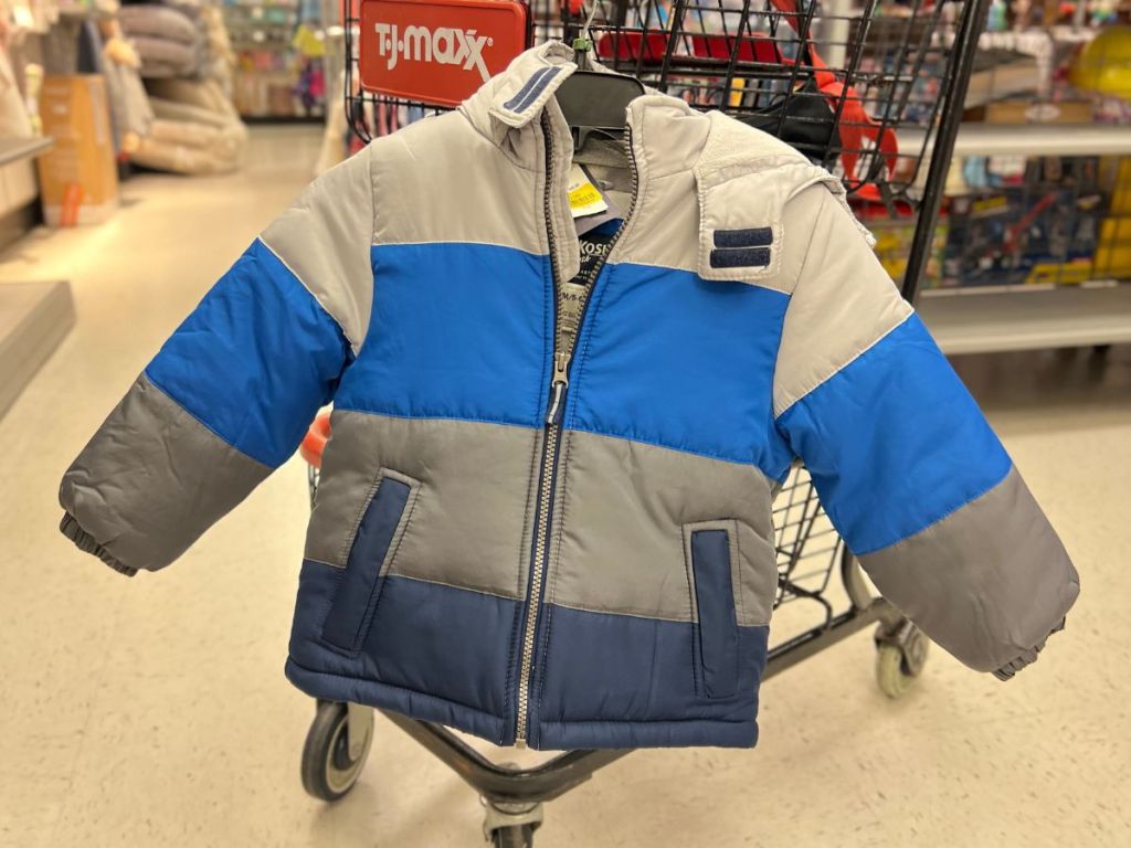 OshKosh Kids Jacket hanging on a cart