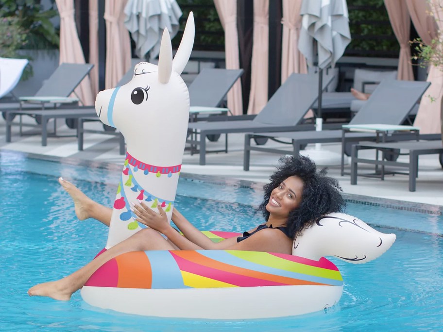 woman floating in a white llama pool float