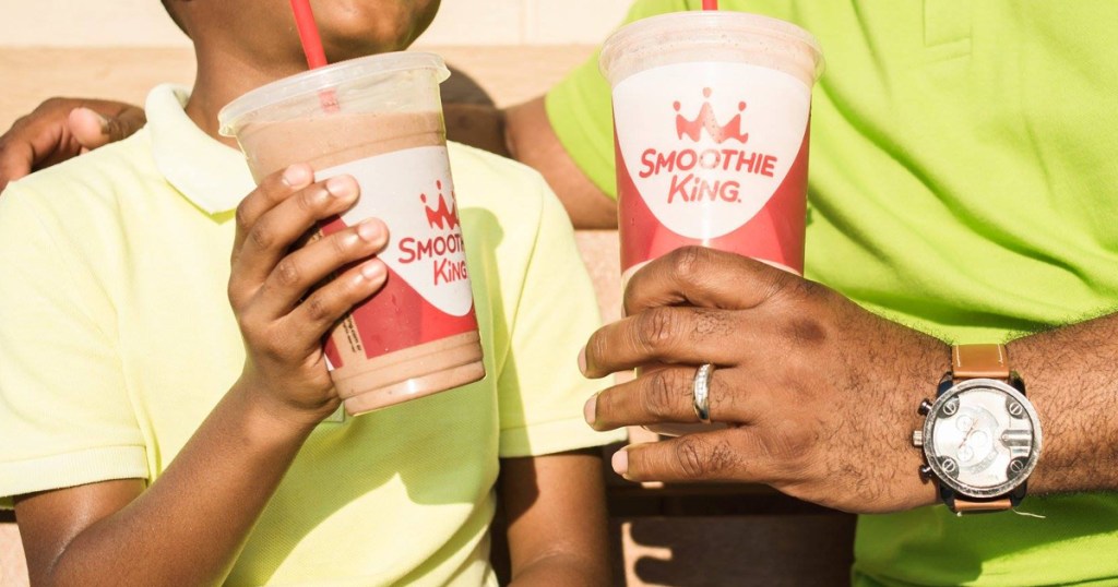 dad and kid drinking smoothie king smoothies
