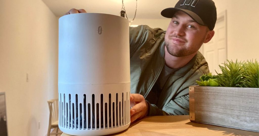 man holding air purifier