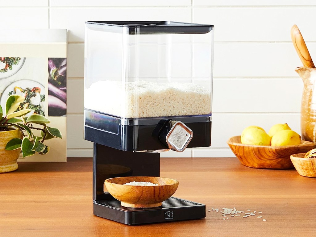 rice in a black food dispenser on a counter