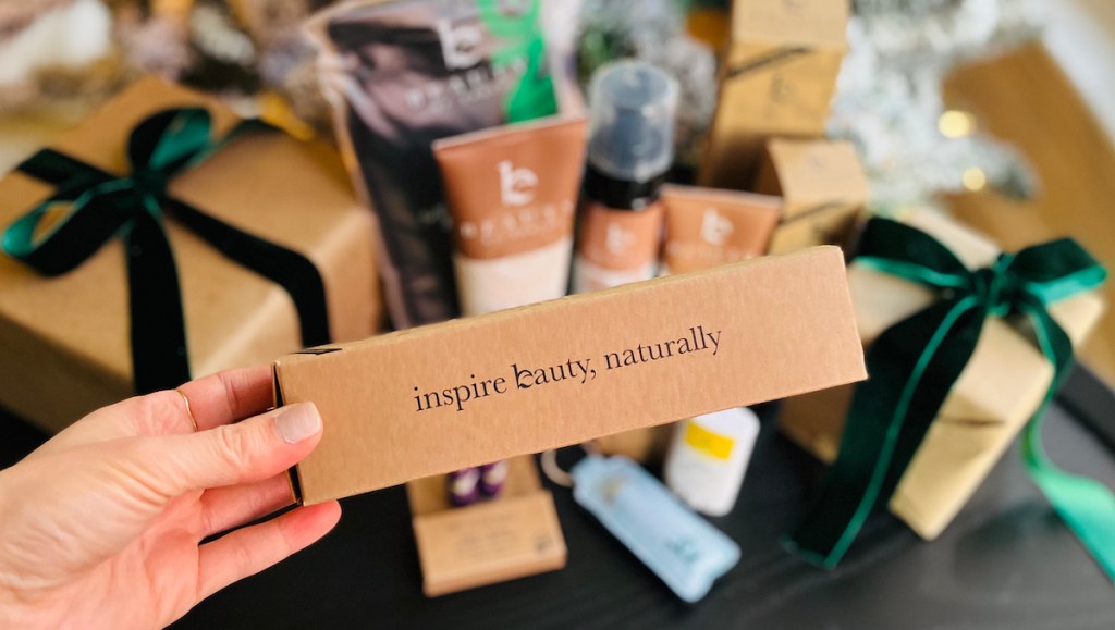 hand holding brown box with inspire beauty naturally