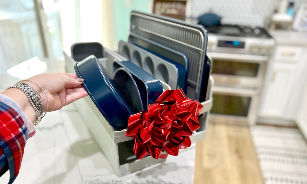 hand holding blue caraway bakeware set sitting on kitchen counter for mothers day gifts 2023