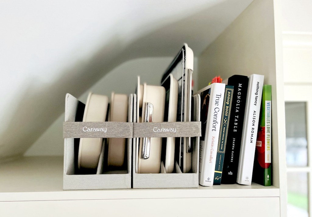 caraway bakeware in storage organizers on shelf with cookbooks