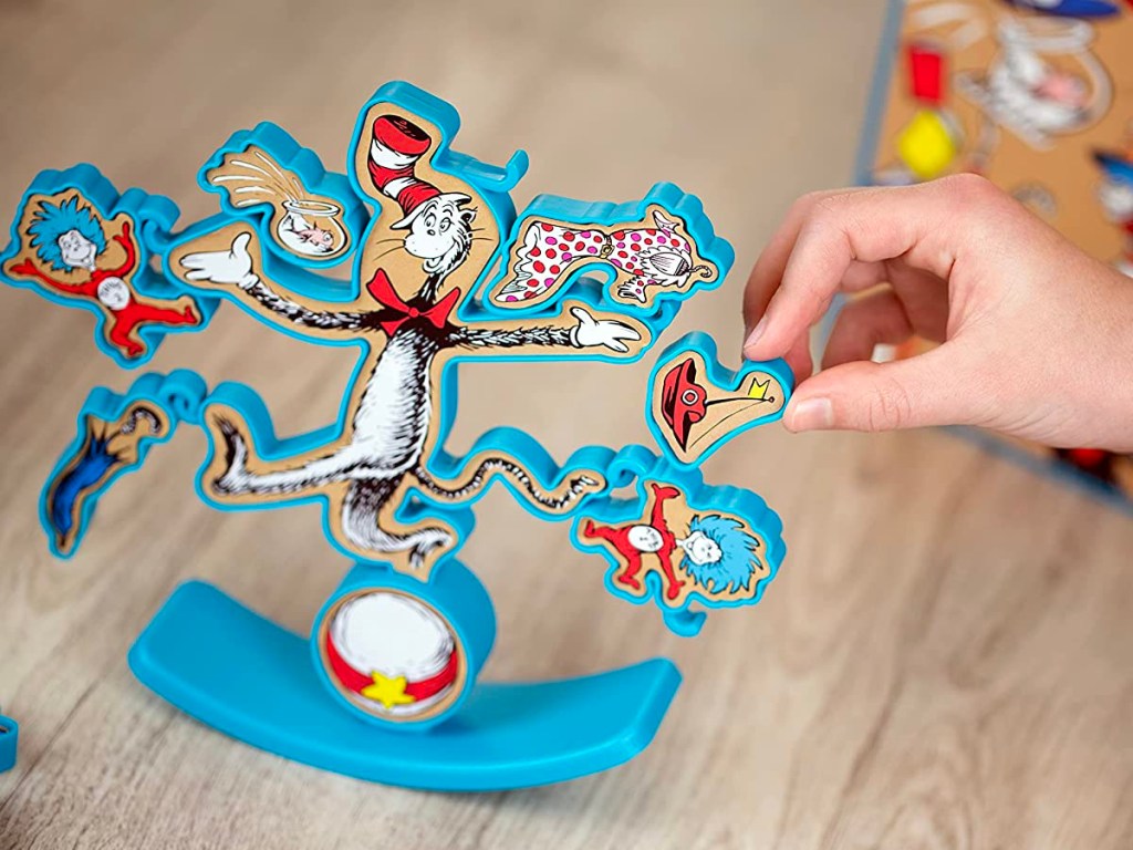 hand putting piece onto dr suess cat game
