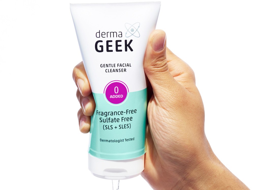 hand squeezing tube of dermaGEEK facial cleanser