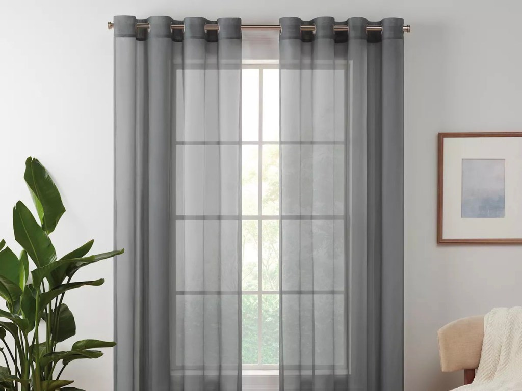 sheer gray window curtain hanging at window