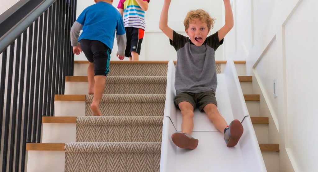 kiddo going down the stairs using stairslide