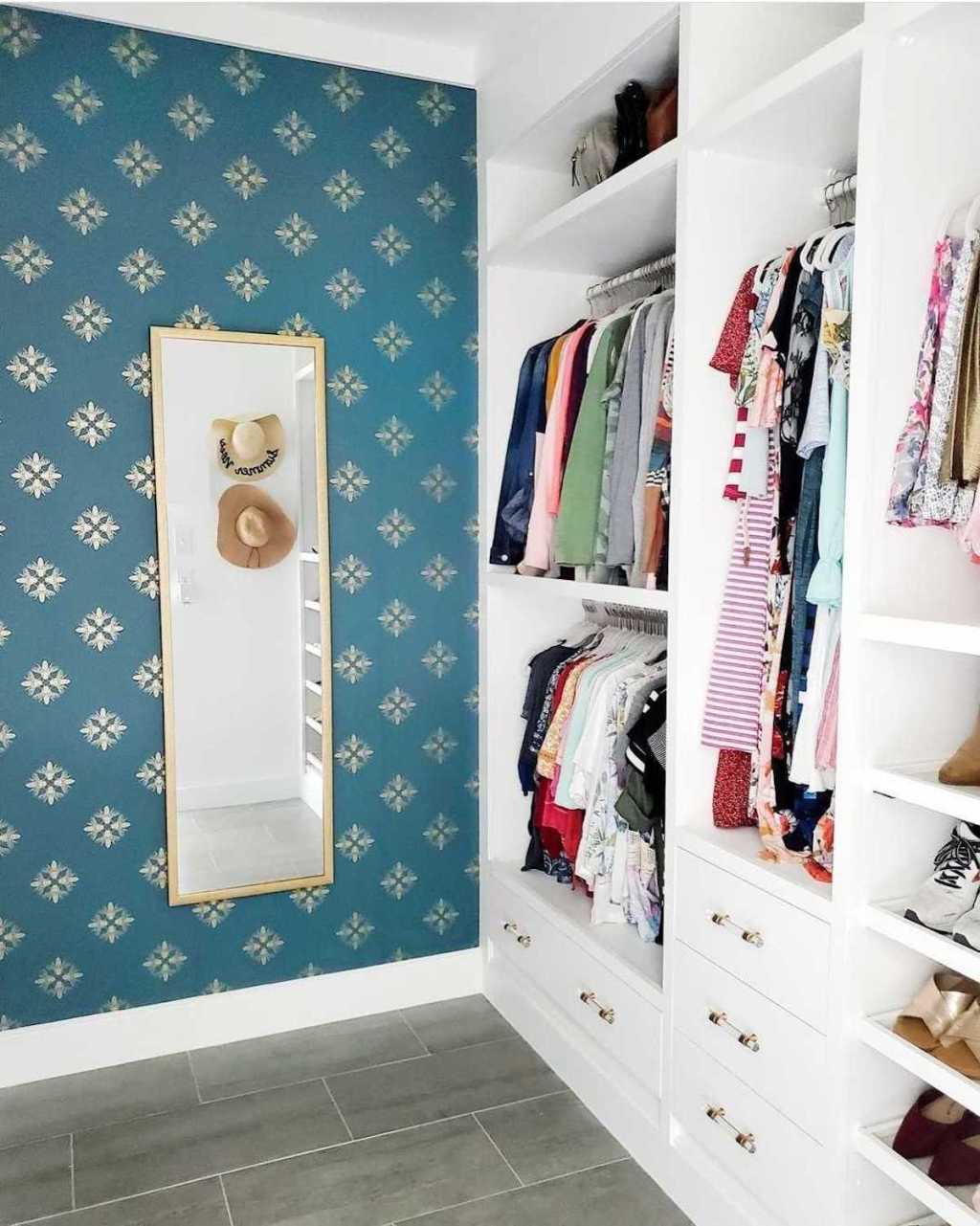 walk in closet with blue flower wallpaper