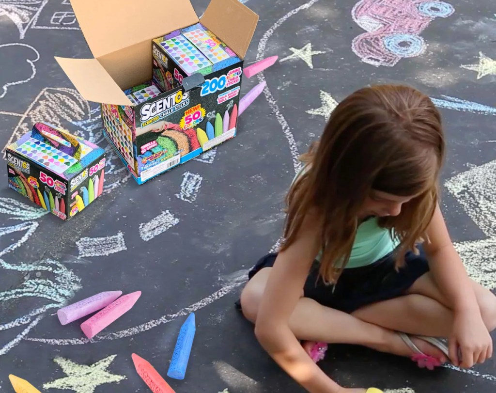 girl drawing on concrete with scentos chalk