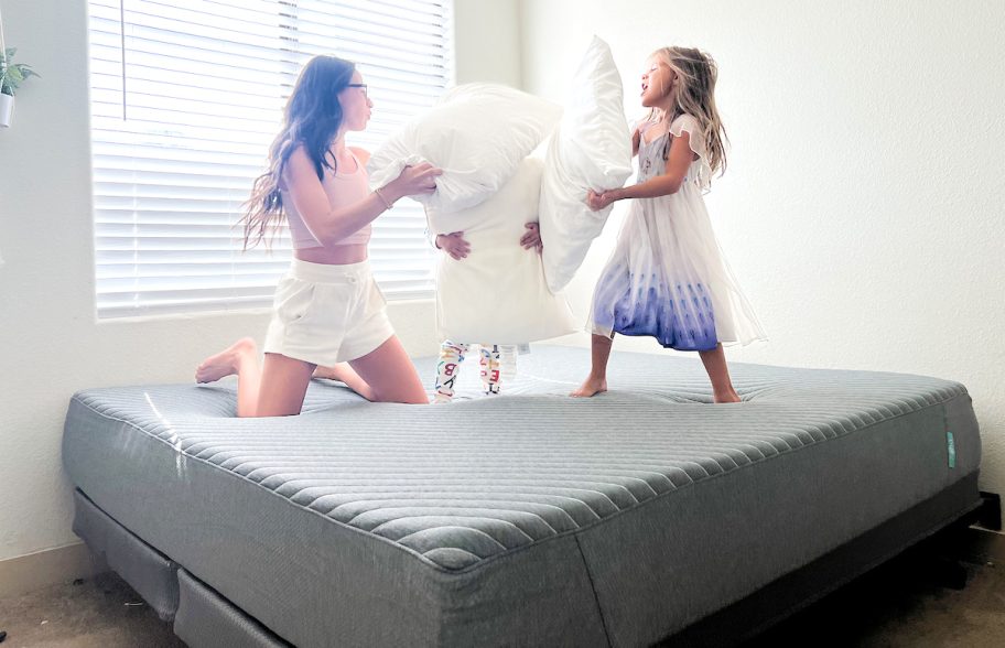 woman and kids having a pillow fight on siena mattress