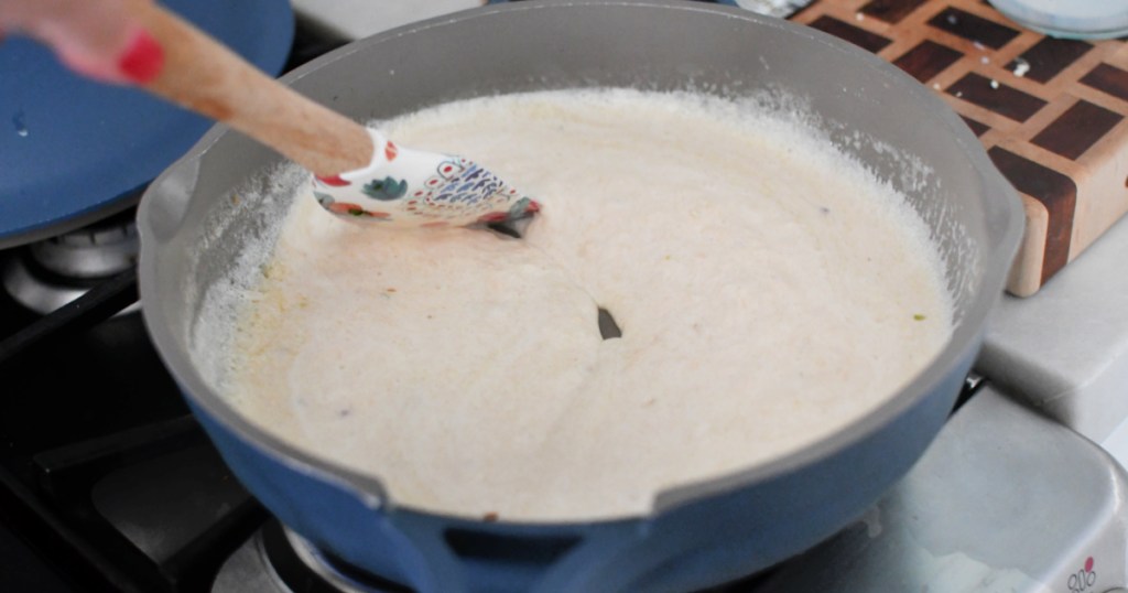 stirring alfredo sauce