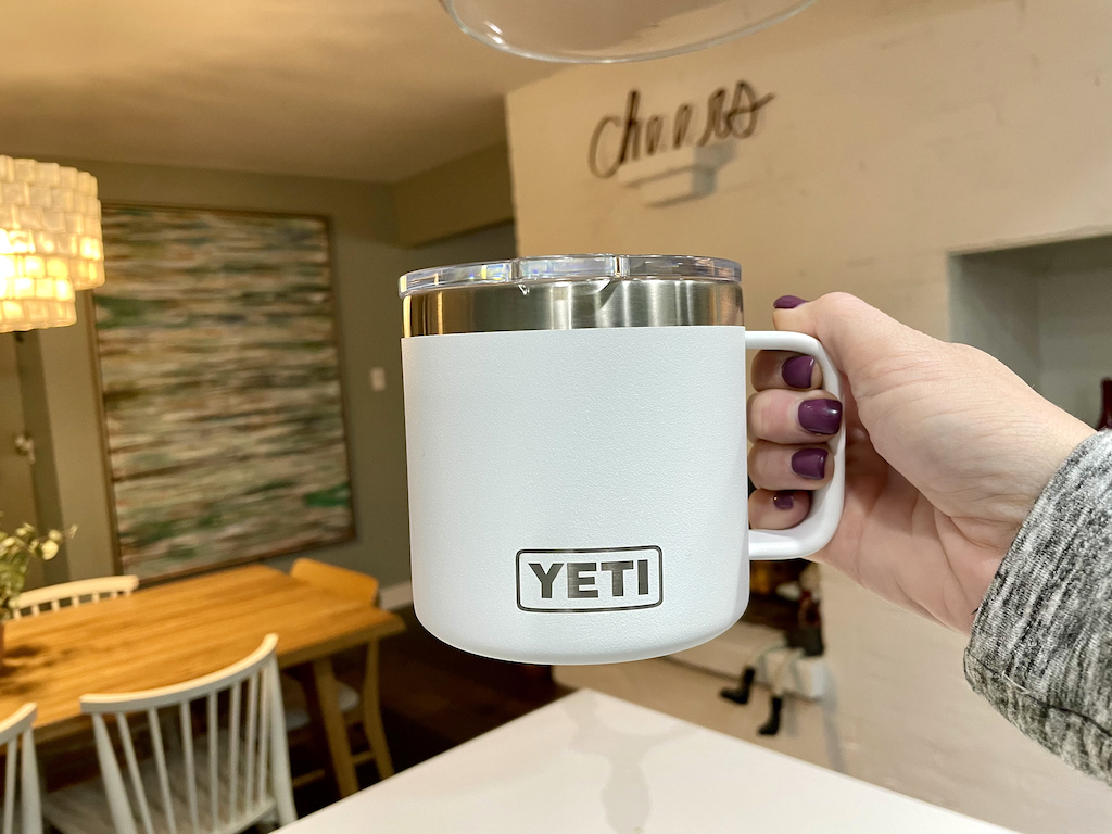 holding YETI mug tumbler in house