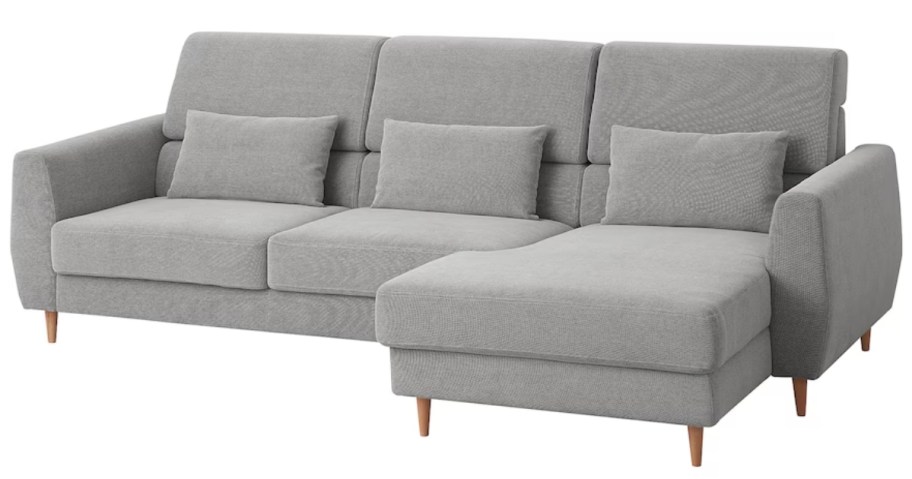 a grey sofa with a chaise lounge on one end