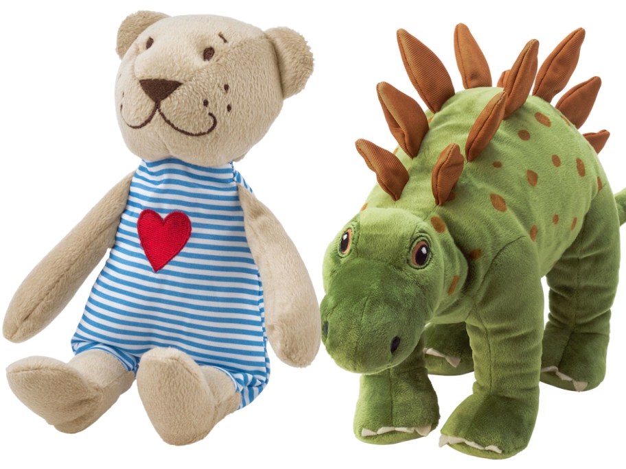 a teddy bear in a blue and white jumpsuit with a red heart anda green dinosaur plush animal