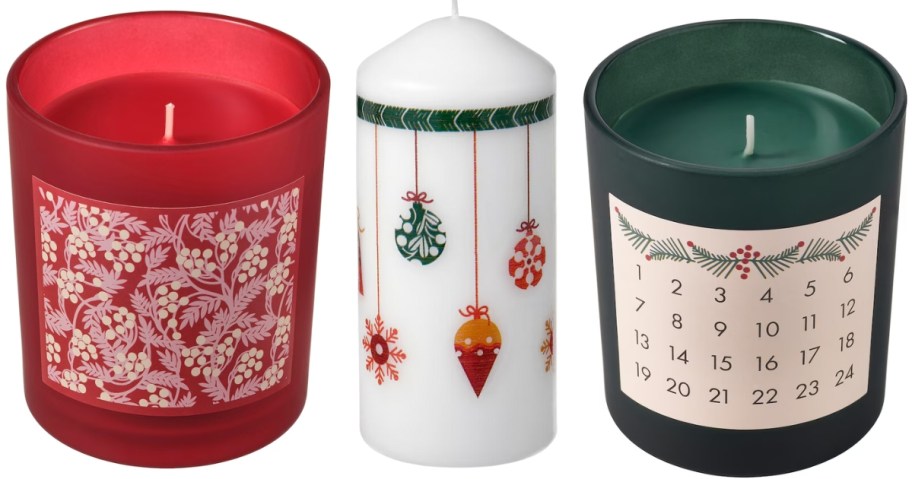 Christmas candles, one red jar candle, one white taper candle with ornaments on it and a green jar candle with a countdown to Christmas calendar on it