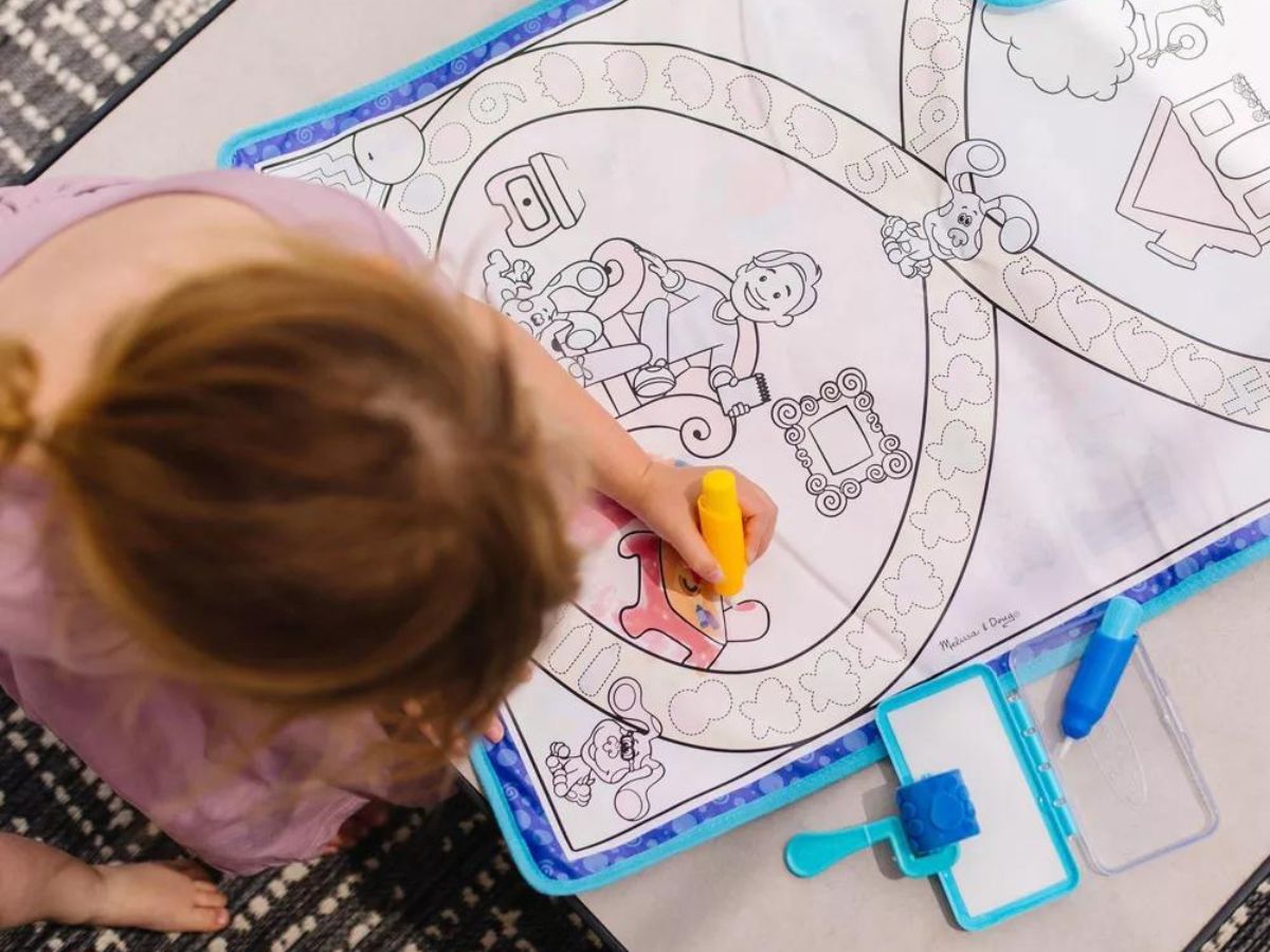 girl playing with a Blue's Clues Water Mat