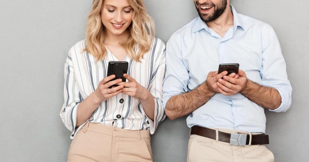 man and woman holding cell phones