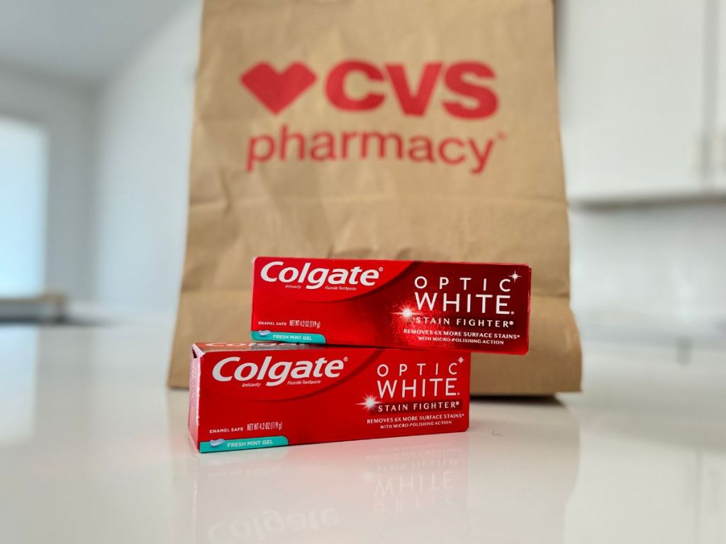 Colgate Optic White toothpaste in front of CVS shopping bag