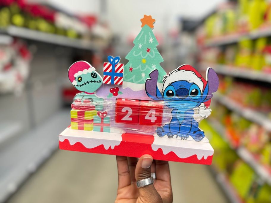 hand holding Disney Christmas Days Until Stitch