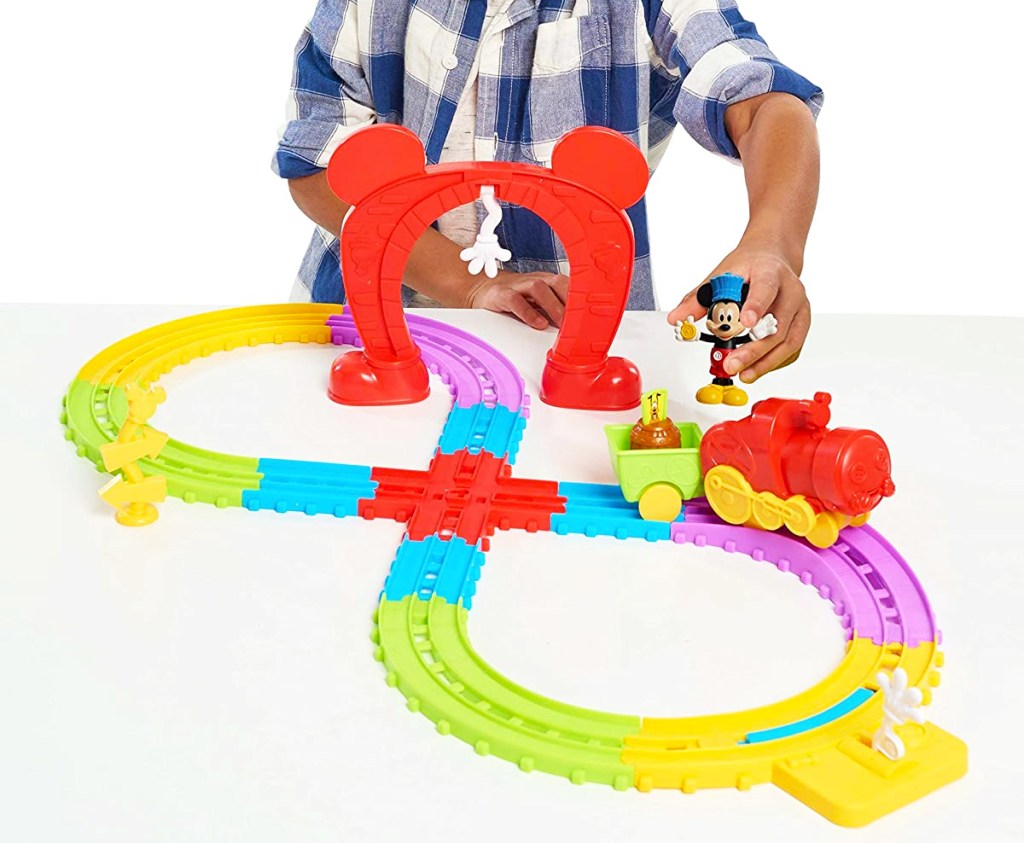 boy playing with Disney Mickey&rsquo;s Musical Express Train Set
