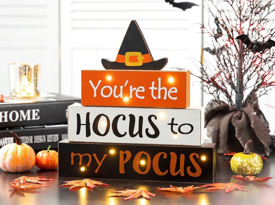 a lighted halloween signe that ready youre the hocus to my pocus sitting on a table top