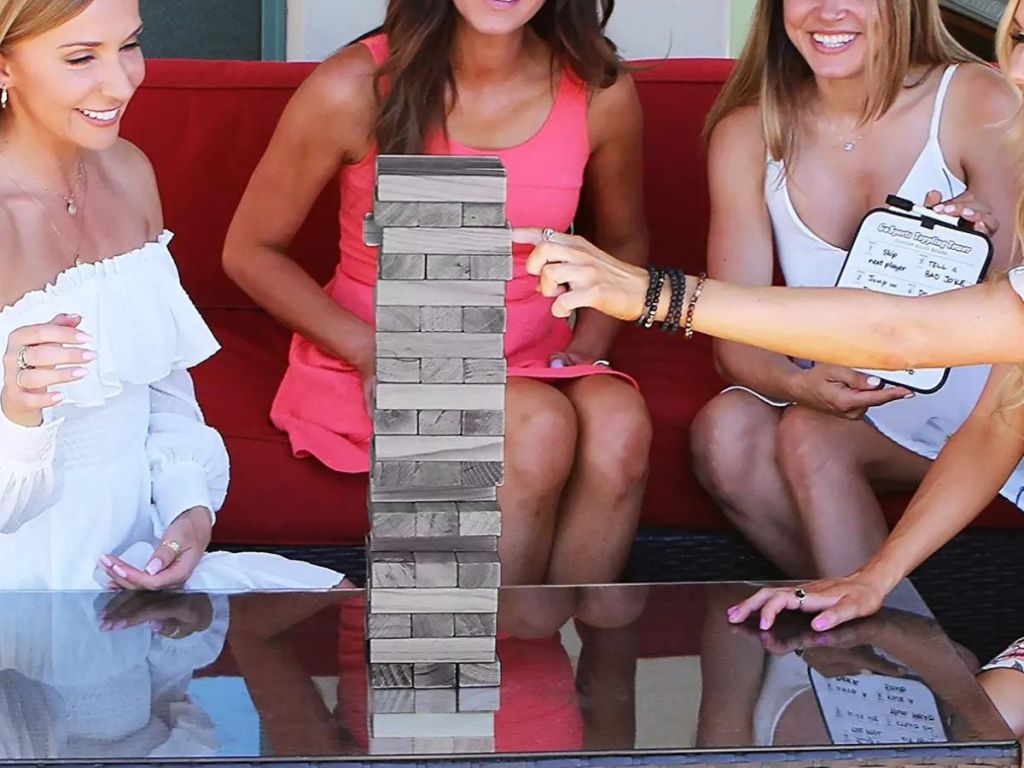 group of people playing with a Go Sports Toppling Tower