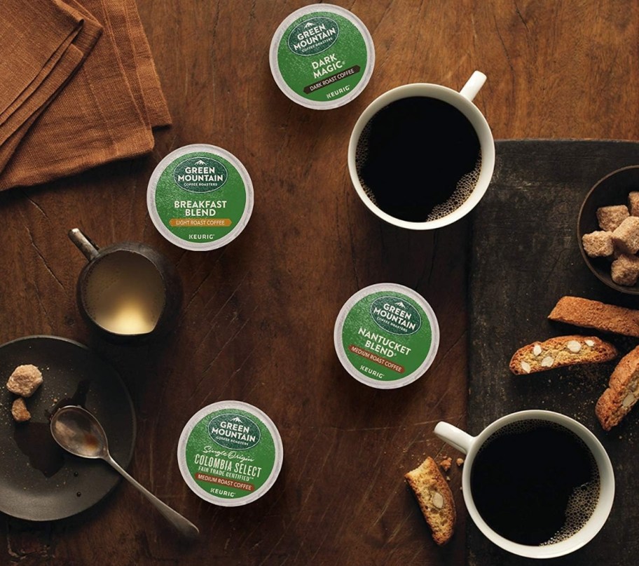 Green Mountain Coffee pods on a table with coffee cups and biscuits