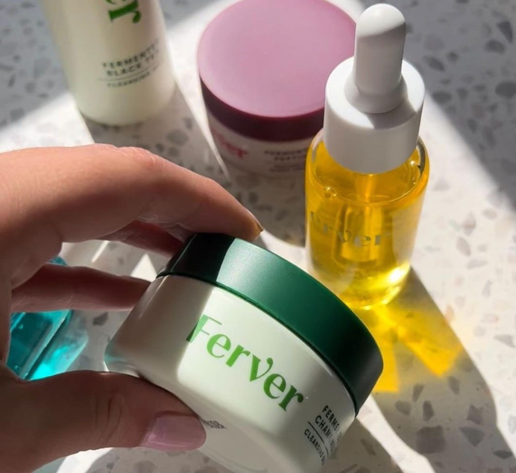 Hand holding Ferver products