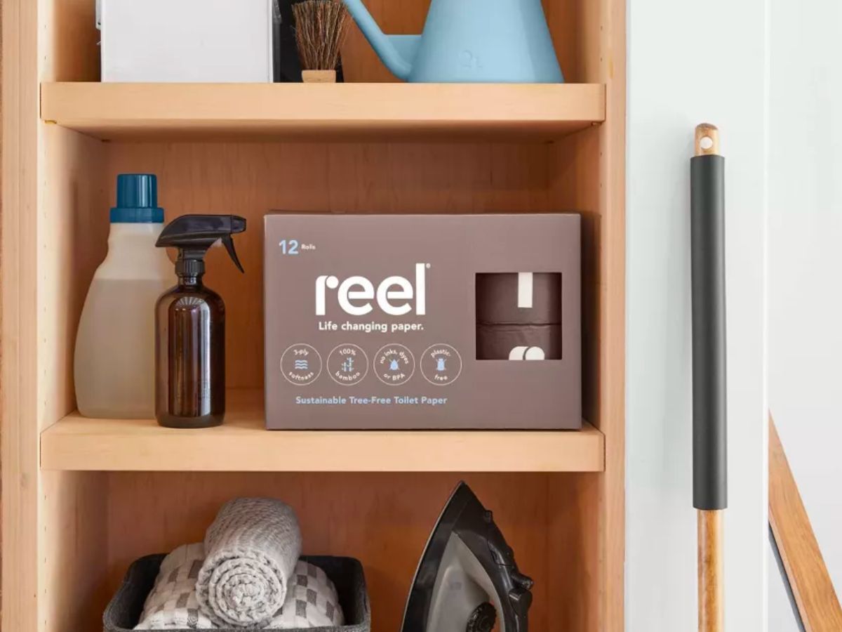 a box of Reel toilet paper 12ct on a bathroom closet shelf