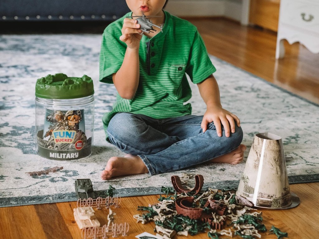 boy playing with military playset