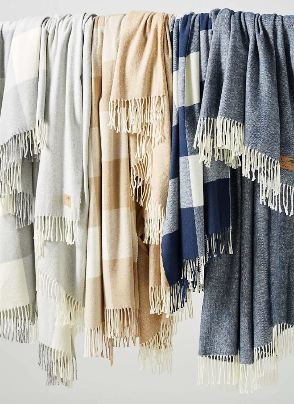 herringbone blankets hanging on pole