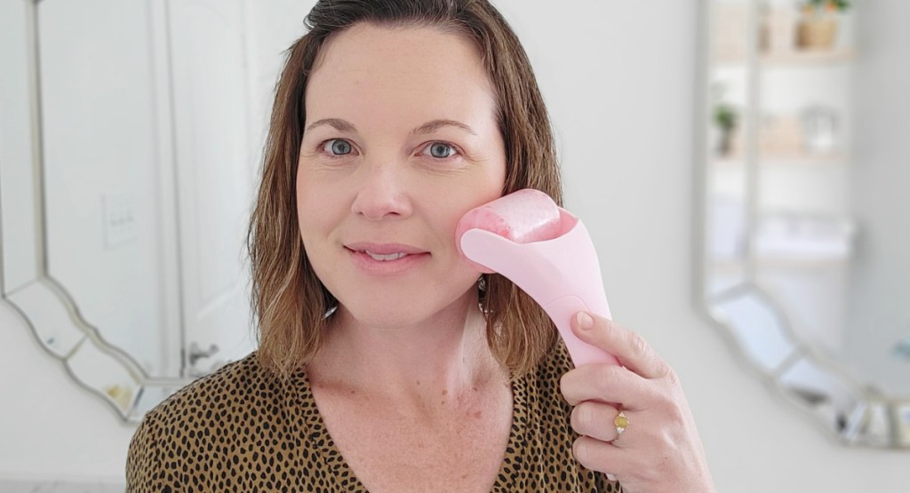 woman using facial roller