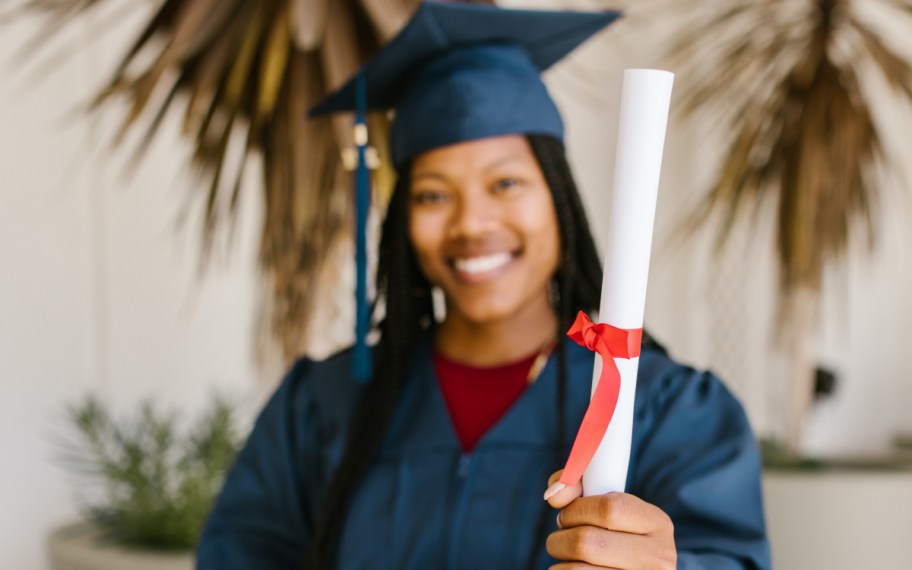 graduate holding diploma