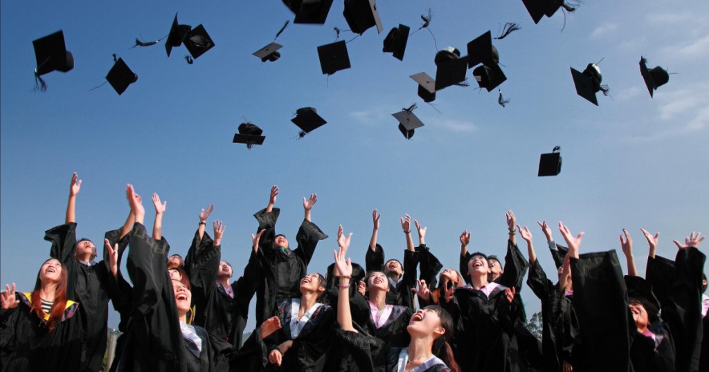 graduates throwing hats in the air