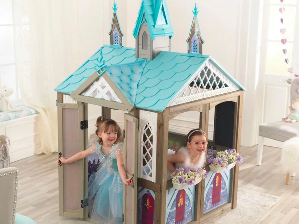 two girls playing with kidkraft disney frozen playhouse 